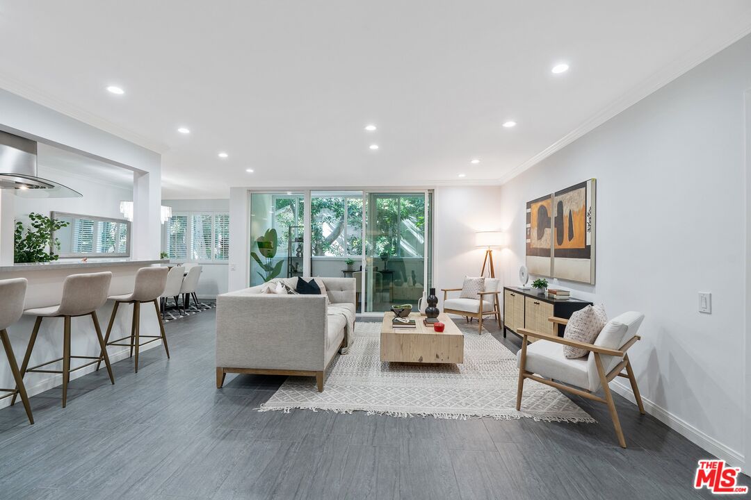 1015 North Kings Road, Unit 110 West Hollywood, CA 90069 - Photo 4 of 38 a living room with furniture and a large window