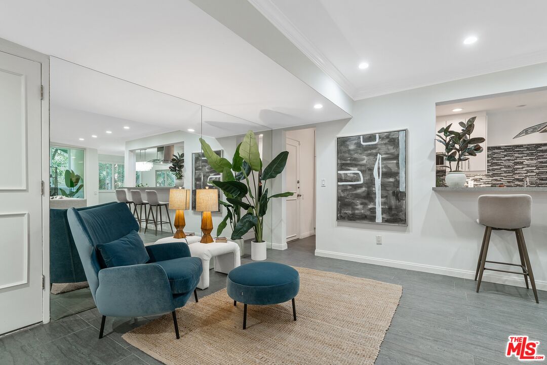 1015 North Kings Road, Unit 110 West Hollywood, CA 90069 - Photo 6 of 38 a living room with furniture and a potted plant