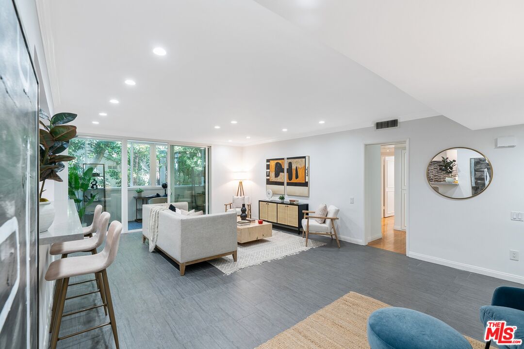 1015 North Kings Road, Unit 110 West Hollywood, CA 90069 - Photo 7 of 38 a living room with furniture and a large window