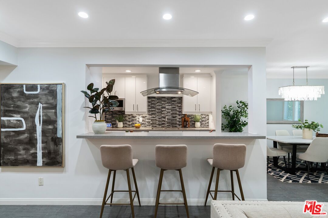 1015 North Kings Road, Unit 110 West Hollywood, CA 90069 - Photo 9 of 38 a kitchen with a table and chairs in it