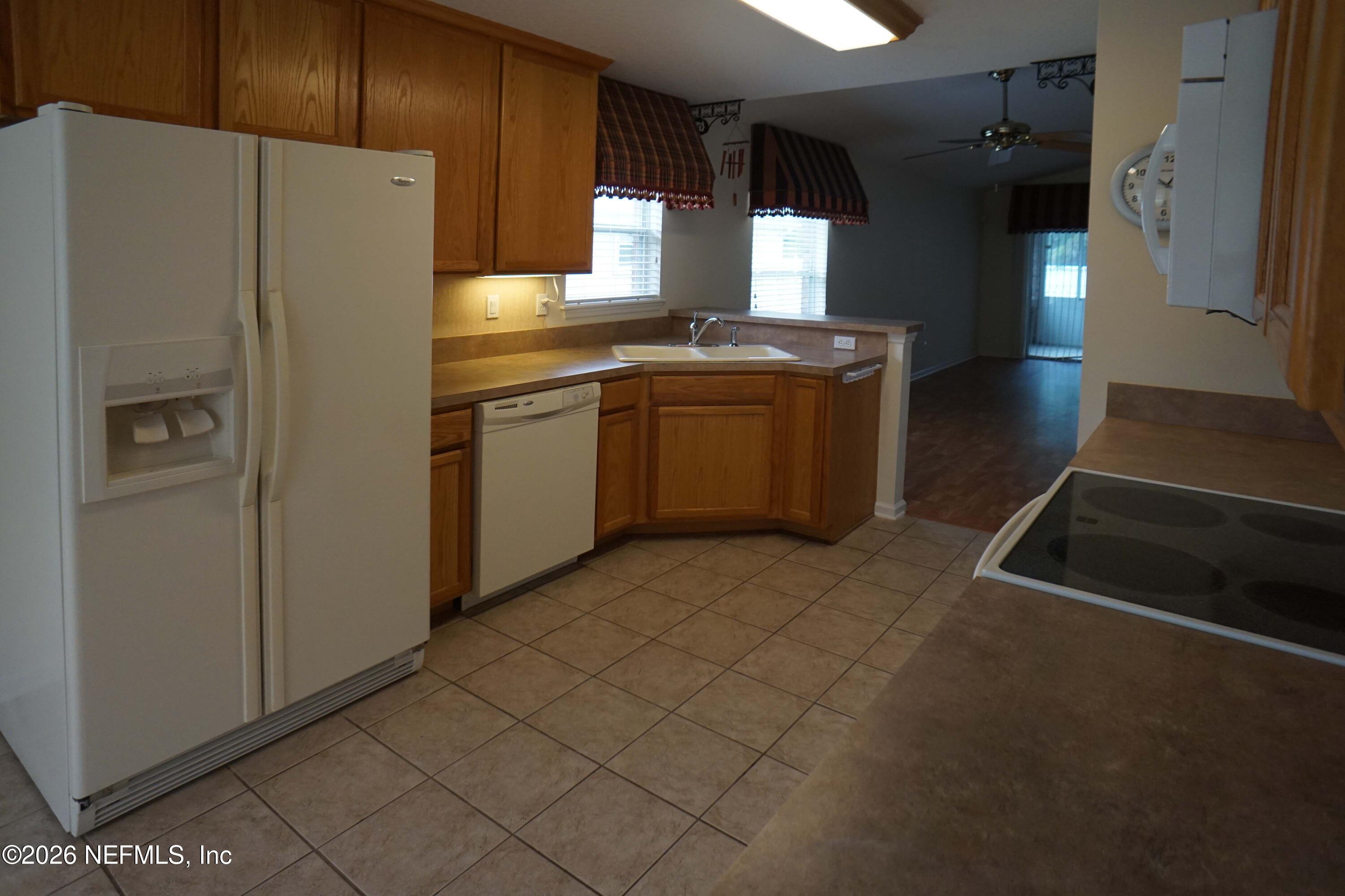 1721 Keswick Road St. Augustine, FL 32084 - Photo 5 of 17 a kitchen with a refrigerator sink and cabinets