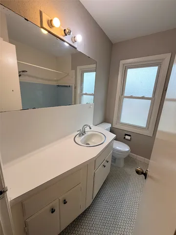 a bathroom with a sink a toilet and mirror