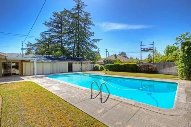 a view of a swimming pool with a lounge chairs