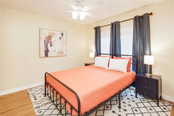 a bedroom with a bed and wooden floor