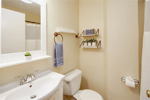 a bathroom with a sink mirror bathtub and toilet