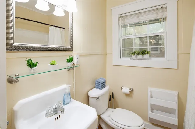 a white toilet sitting next to a bathroom sink