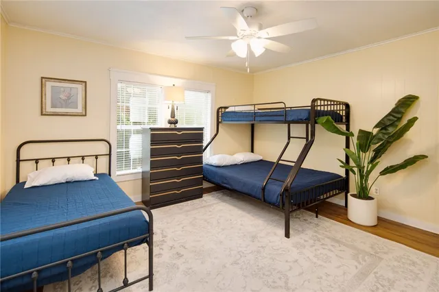 a bedroom with furniture and a ceiling fan