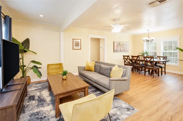 a living room with furniture wooden floor and a flat screen tv
