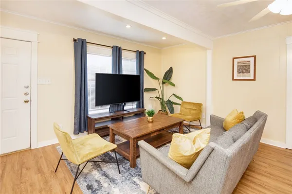 a work room with furniture and a flat screen tv