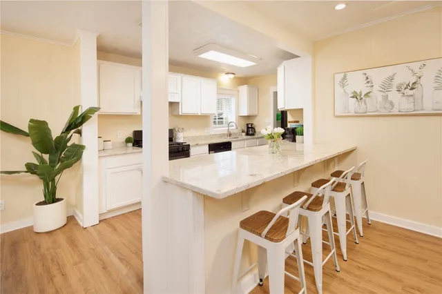 a kitchen with a sink a counter space and a dining table