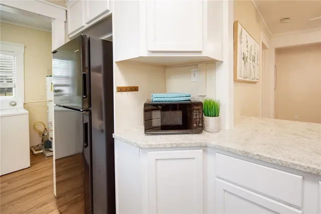 a kitchen with stainless steel appliances granite countertop a refrigerator and a sink