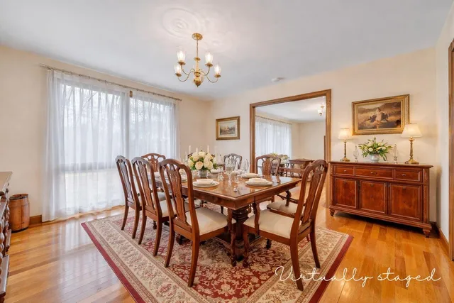 a spacious bathroom with a sink a toilet and mirror