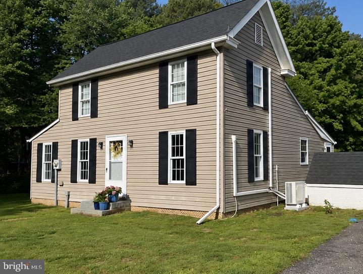 1610 Hudson Road Cambridge, MD 21613 - Photo 1 of 11 Charming home with lush greenery backdrop.