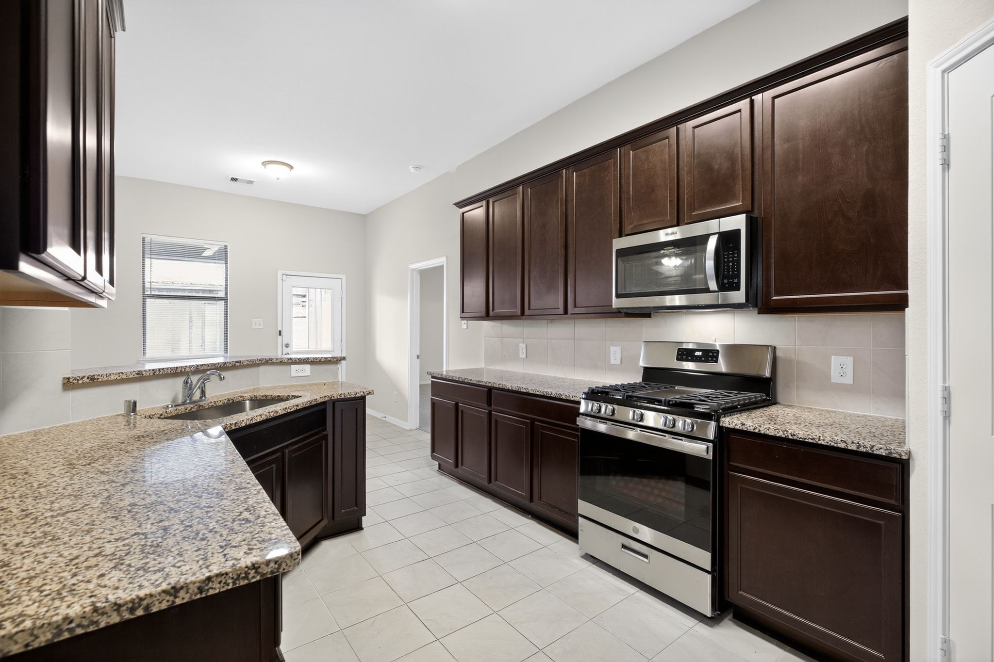 22514 Rustic Valley Court Porter, TX 77365 - Photo 11 of 33 a kitchen with granite countertop stainless steel appliances and sink