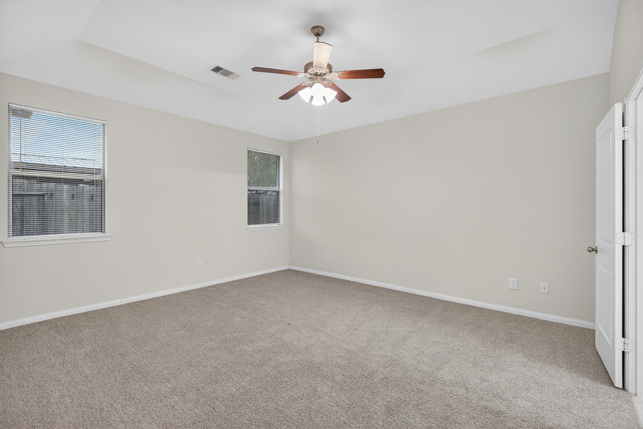 22514 Rustic Valley Court Porter, TX 77365 - Photo 18 of 33 a view of an empty room with a ceiling fan and a window