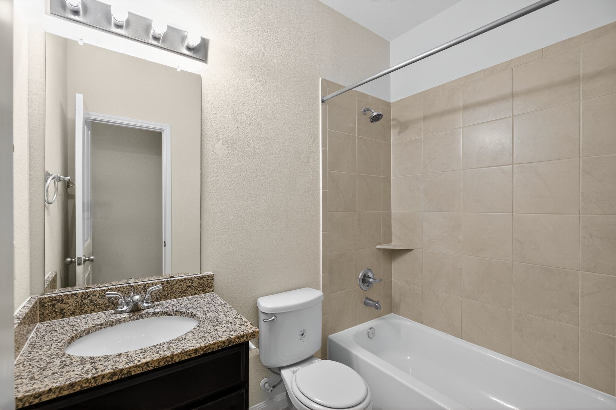 22514 Rustic Valley Court Porter, TX 77365 - Photo 24 of 33 a bathroom with a granite countertop sink toilet and shower