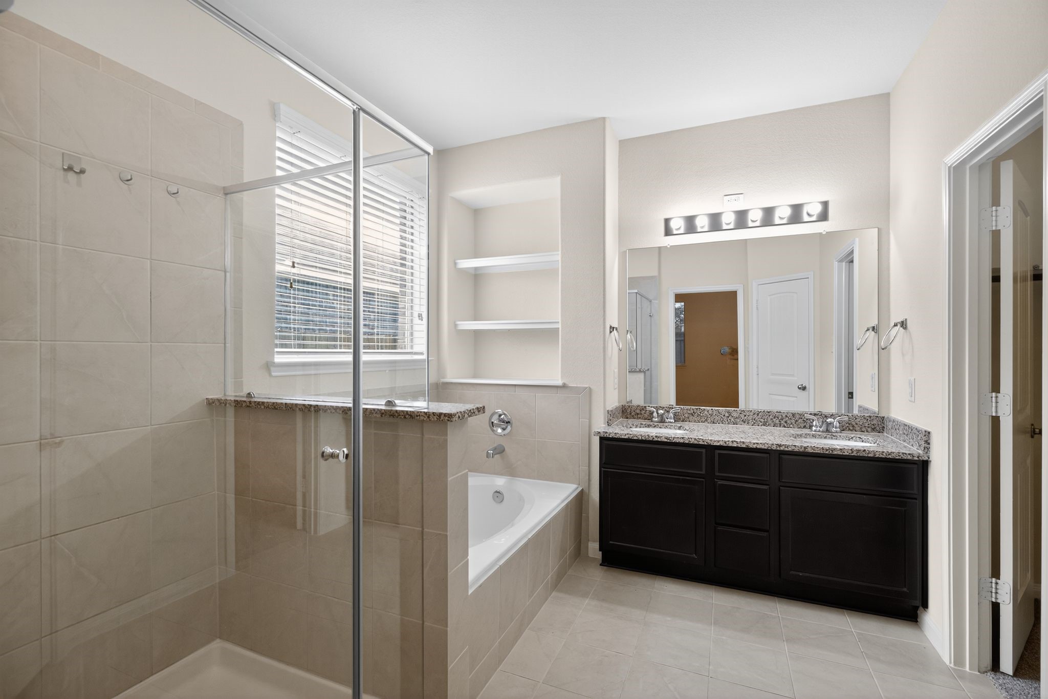 22514 Rustic Valley Court Porter, TX 77365 - Photo 25 of 33 a spacious bathroom with double vanity and a bathtub