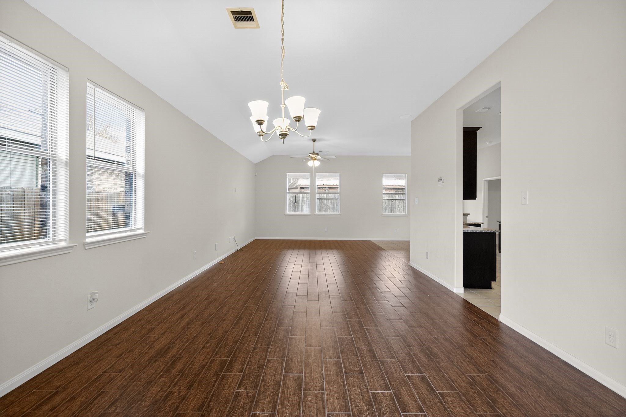 22514 Rustic Valley Court Porter, TX 77365 - Photo 7 of 33 a view of an empty room with wooden floor and a window