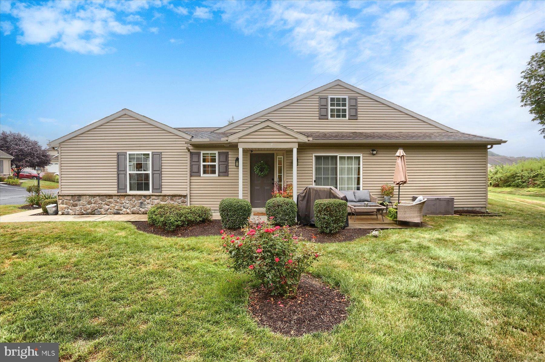 a view of a house with a yard patio and fire pit