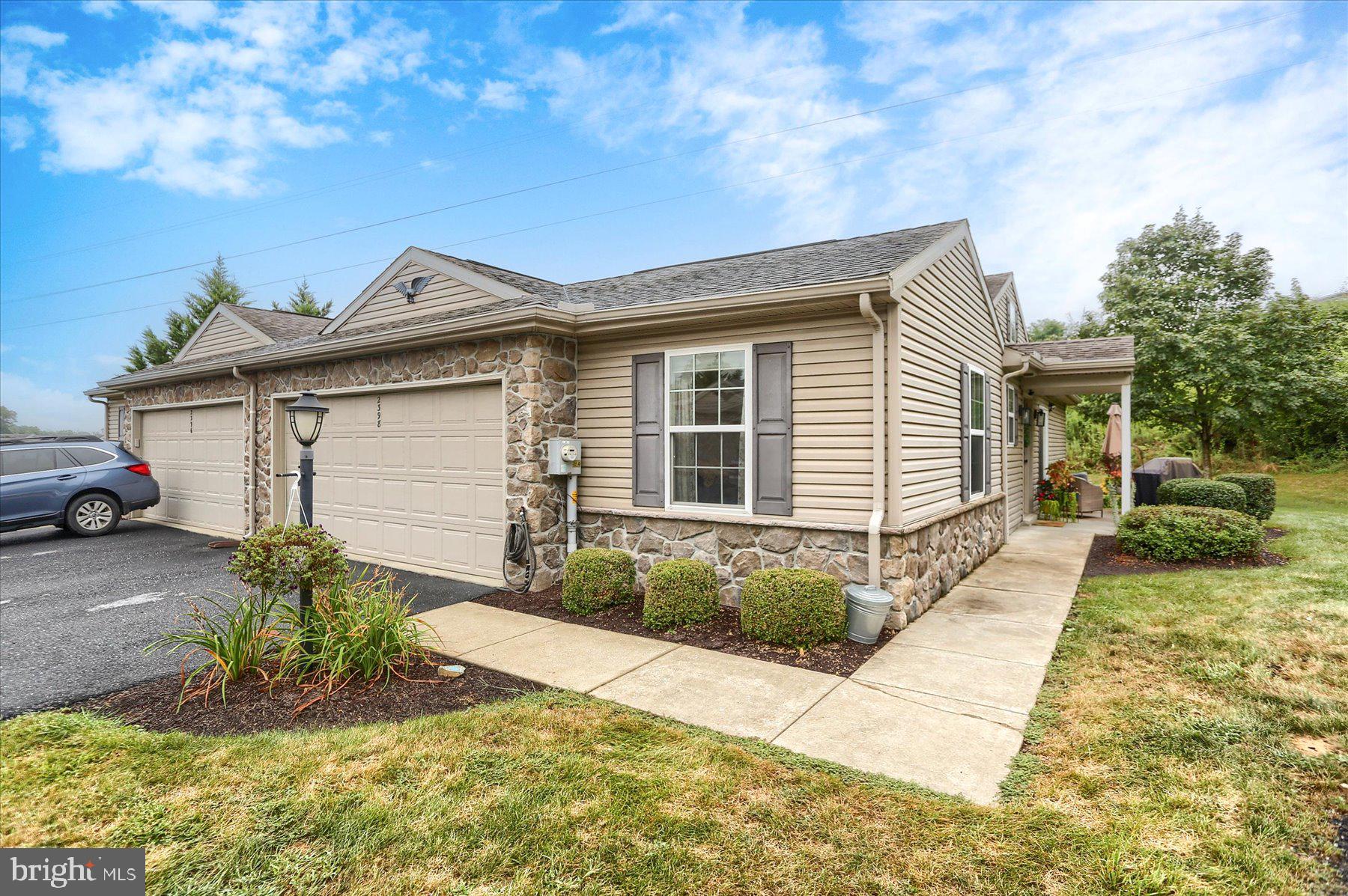 2398 Mill Road Mechanicsburg, PA 17055 - Photo 23 of 24 a front view of a house with a yard and garage