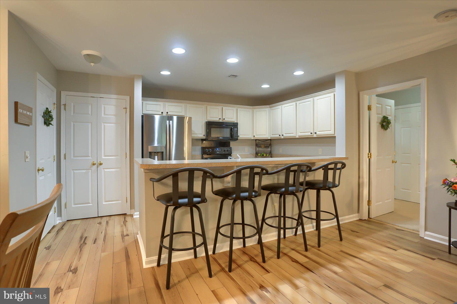 2398 Mill Road Mechanicsburg, PA 17055 - Photo 8 of 24 a kitchen with stainless steel appliances kitchen island granite countertop wooden floors and cabinets