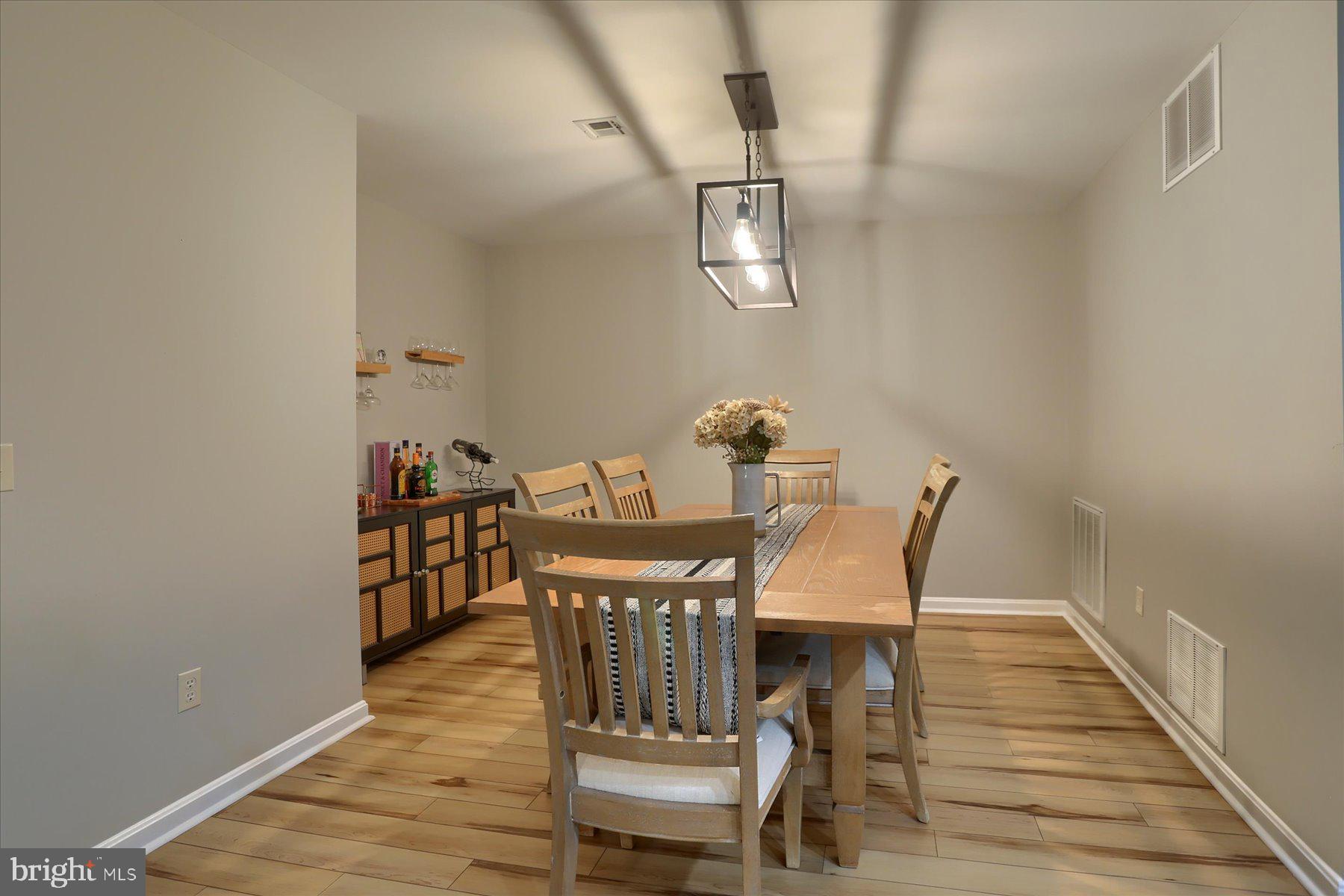 2398 Mill Road Mechanicsburg, PA 17055 - Photo 9 of 24 a view of a dining room with furniture and wooden floor