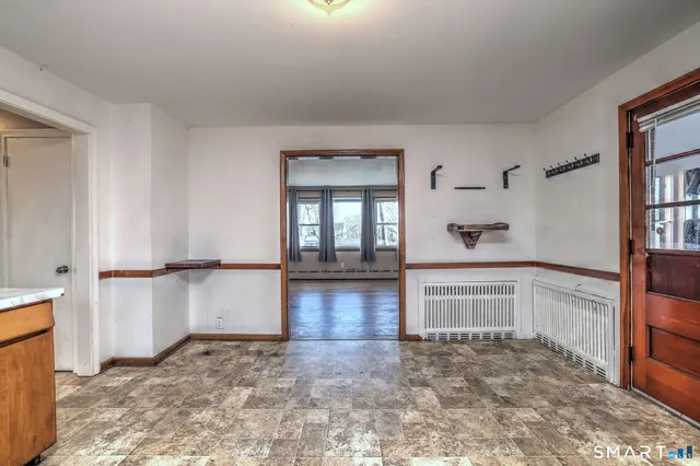 a view of a door and wooden floor in a room