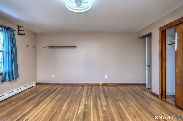 a bathroom with a granite countertop sink mirror vanity and toilet