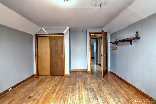 a view of an empty room with wooden walls