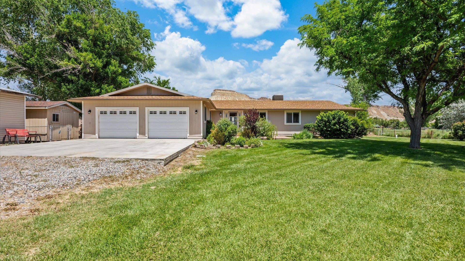 3482 F Road Clifton, CO 81520 - Photo 3 of 30 a front view of a house with a garden