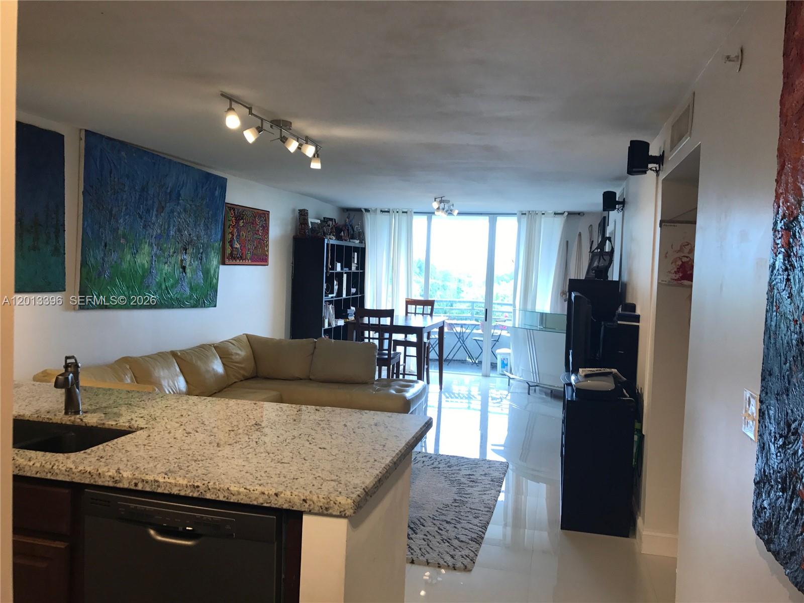 1401 Bay Road, Unit 513 Miami Beach, FL 33139 - Photo 1 of 12 a living room with furniture and a wooden floor
