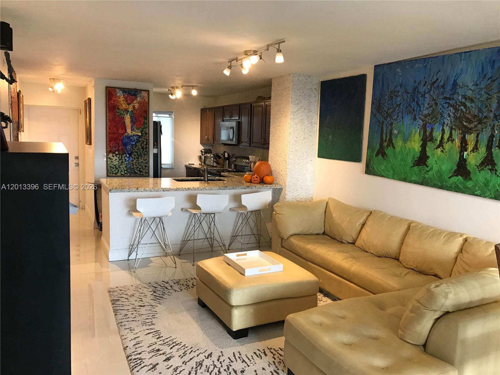 1401 Bay Road, Unit 513 Miami Beach, FL 33139 - Photo 3 of 12 a living room with furniture and a couch