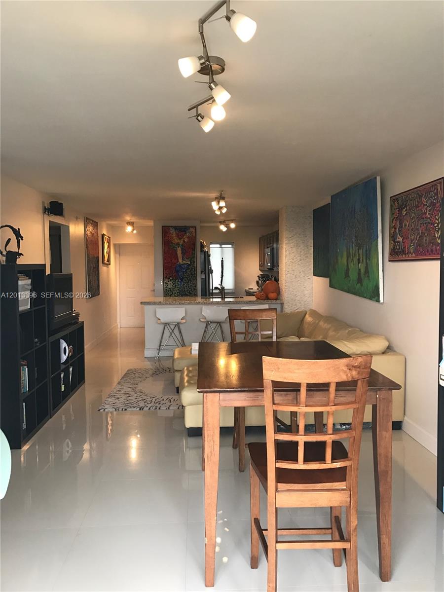 1401 Bay Road, Unit 513 Miami Beach, FL 33139 - Photo 4 of 12 a large kitchen with a table and chairs