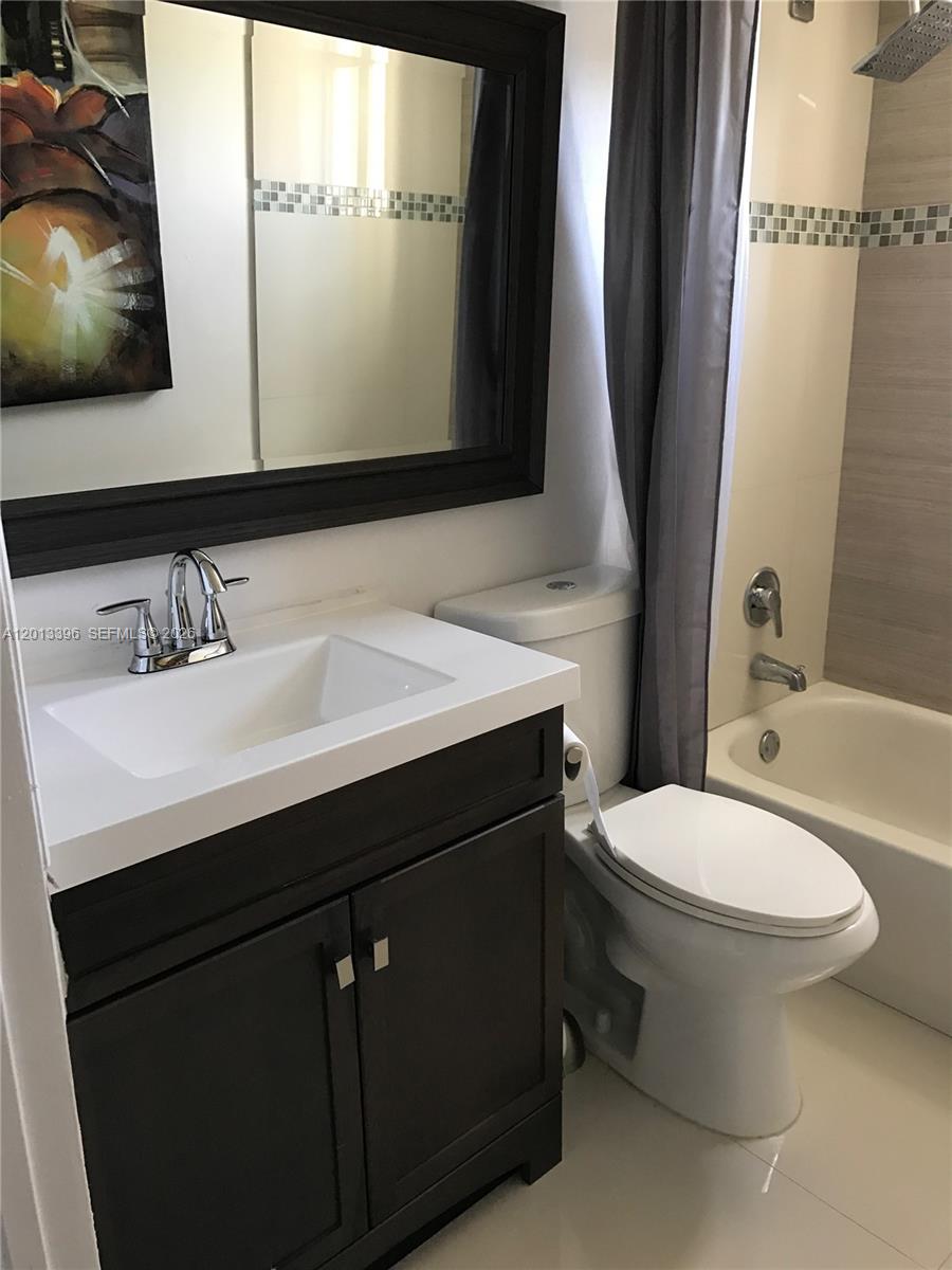 1401 Bay Road, Unit 513 Miami Beach, FL 33139 - Photo 8 of 12 a bathroom with a sink mirror and toilet