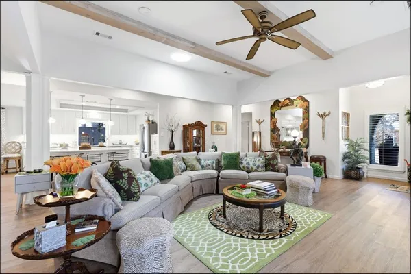 a living room with furniture a rug and a chandelier