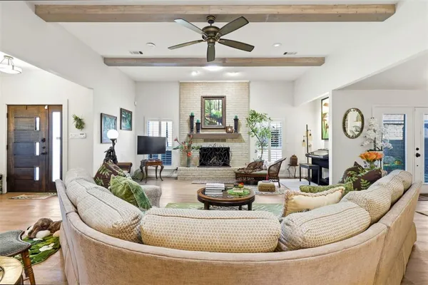 a living room with fireplace furniture and a wooden floor
