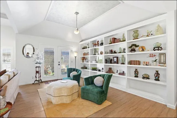 a living room with furniture cabinets and window