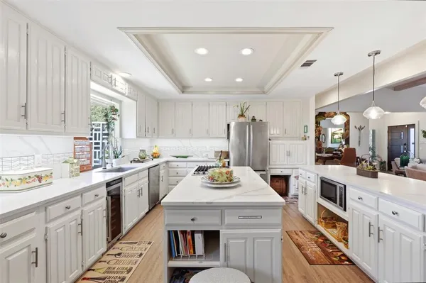 a kitchen with a sink stove and cabinets