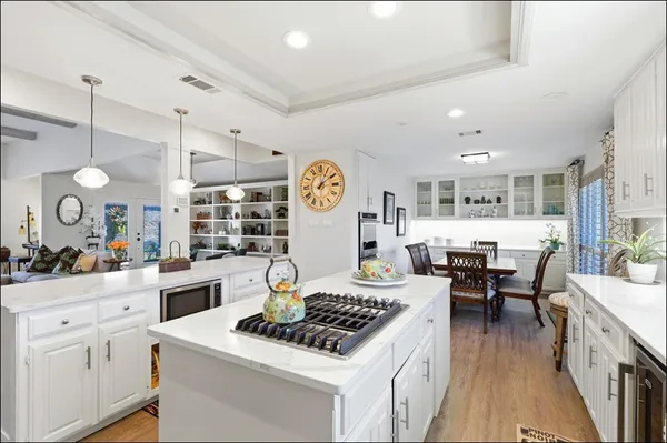 a kitchen with a stove and white cabinets