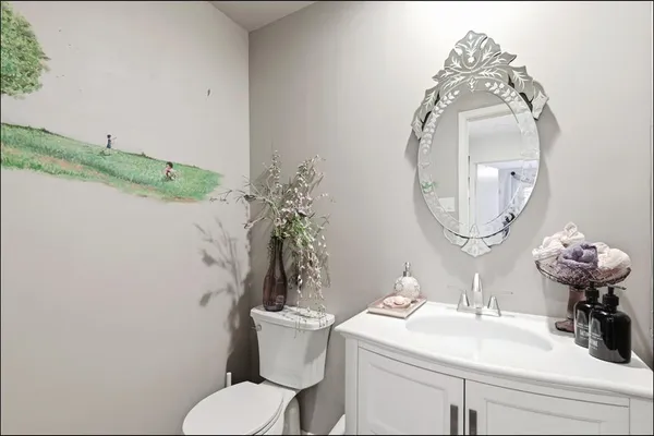 a bathroom with a sink mirror and toilet
