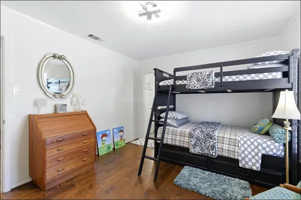 a bedroom with a bed and a dresser