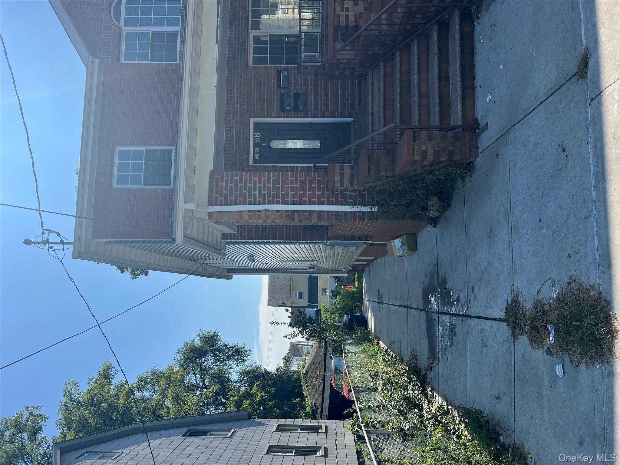 189-22 117th Road Queens, NY 11412 - Photo 2 of 2 a front view of a house with a yard