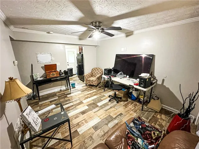 a living room with furniture a air conditioner vent and a window