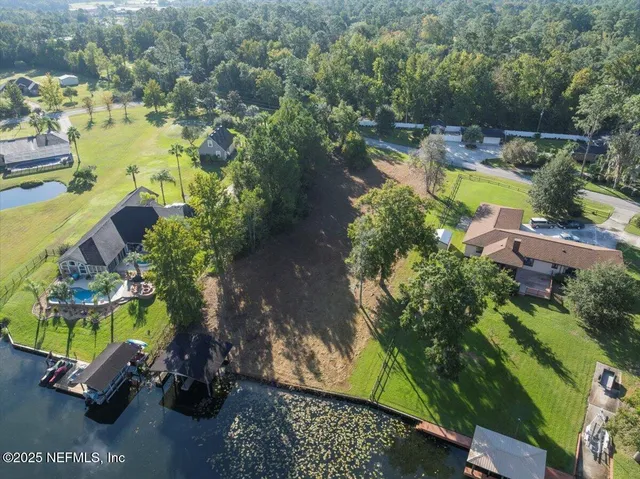 an aerial view of a swimming pool with a yard