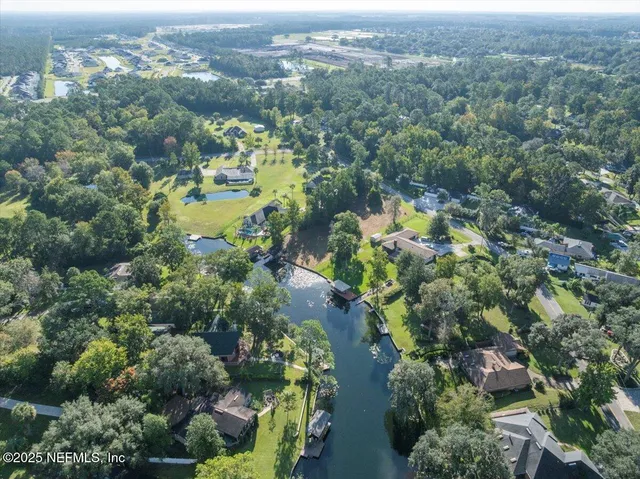 an aerial view of a houses with a yard