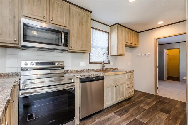 a kitchen with stainless steel appliances a stove microwave and cabinets