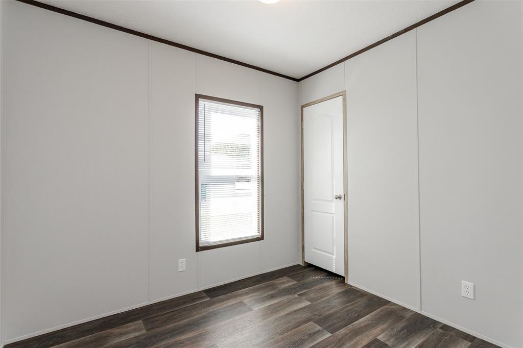 2900 Interstate 35, Unit 197 Waco, TX 76706 - Photo 17 of 24 an empty room with wooden floor and windows