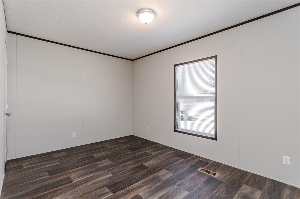 2900 Interstate 35, Unit 197 Waco, TX 76706 - Photo 19 of 24 an empty room with wooden floor and windows
