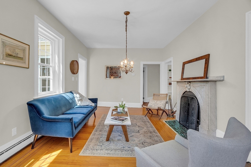 47 Center Bridge Road Lancaster, MA 01523 - Photo 11 of 42 a living room with furniture and a chandelier