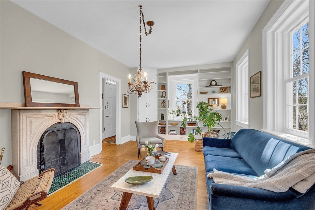 47 Center Bridge Road Lancaster, MA 01523 - Photo 12 of 42 a living room with furniture a fireplace and a chandelier